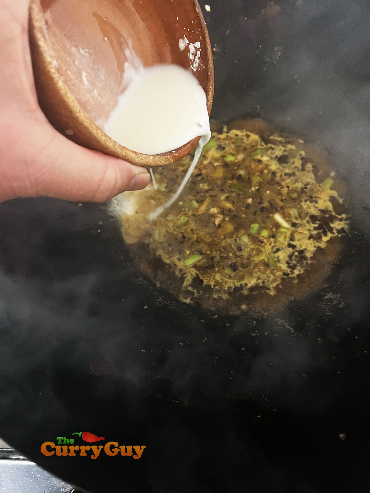 Adding the sauce ingredients and the slurry.