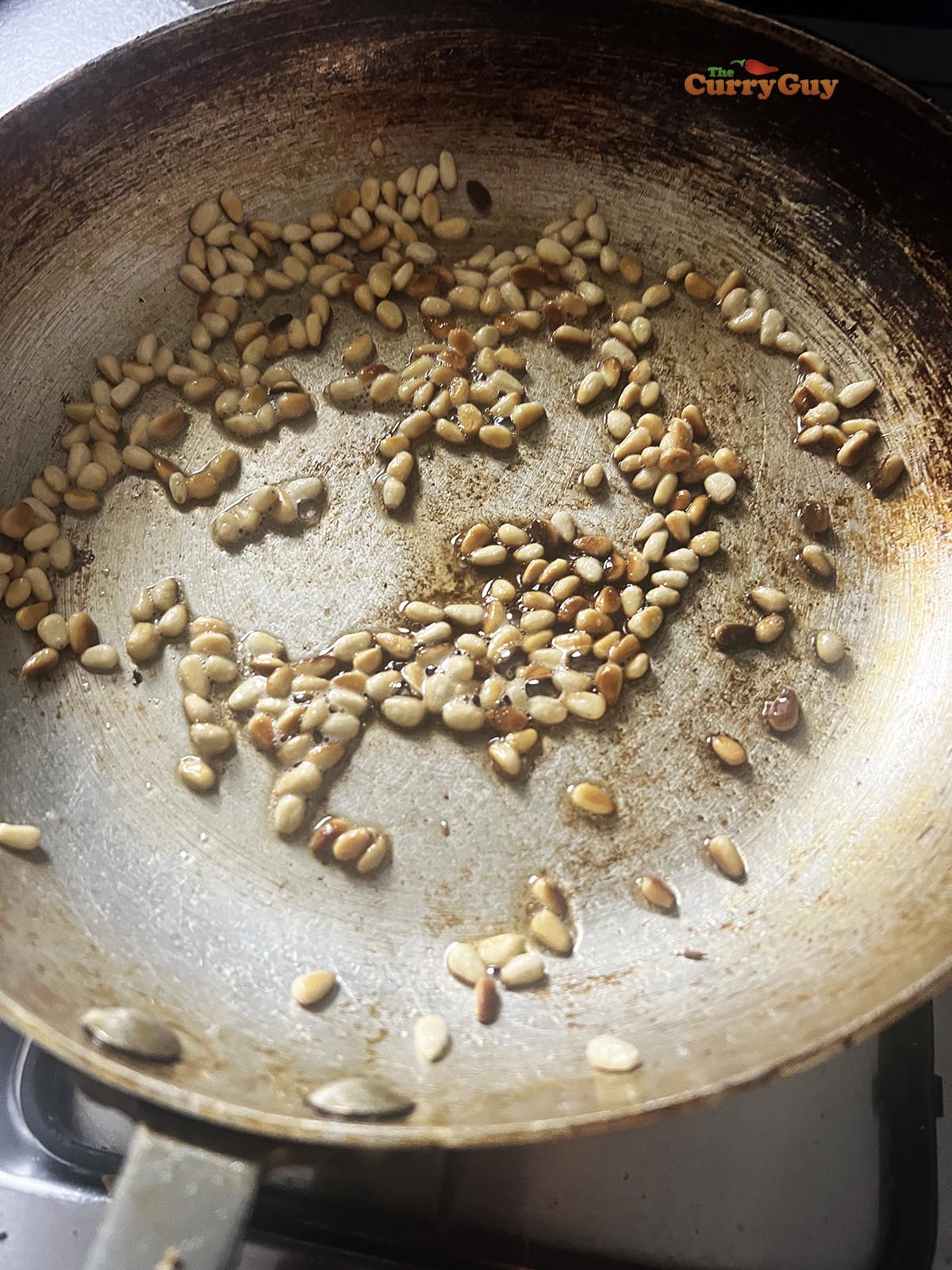Frying pine nuts.