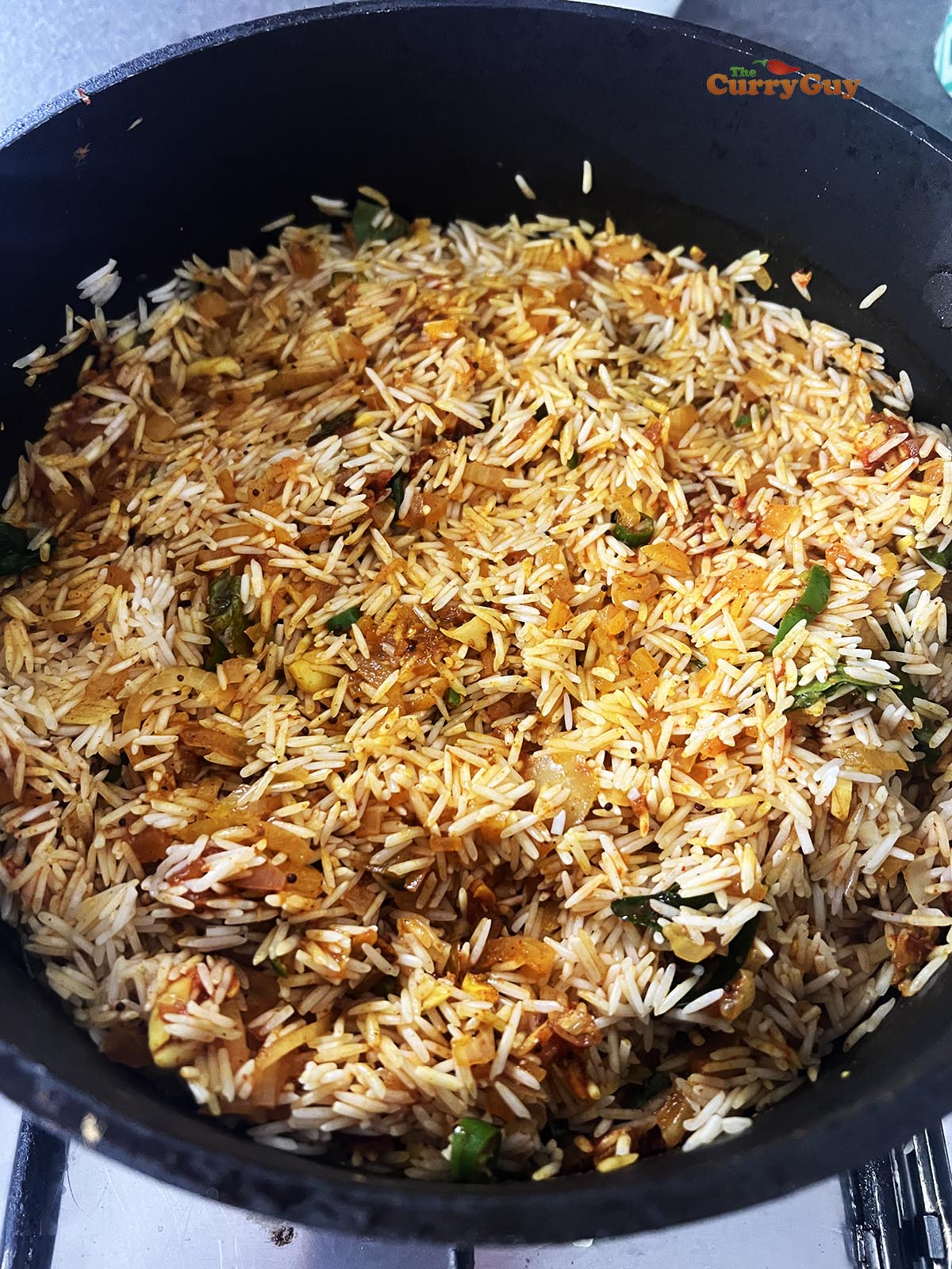 Adding rice to the spice and onion mixture.