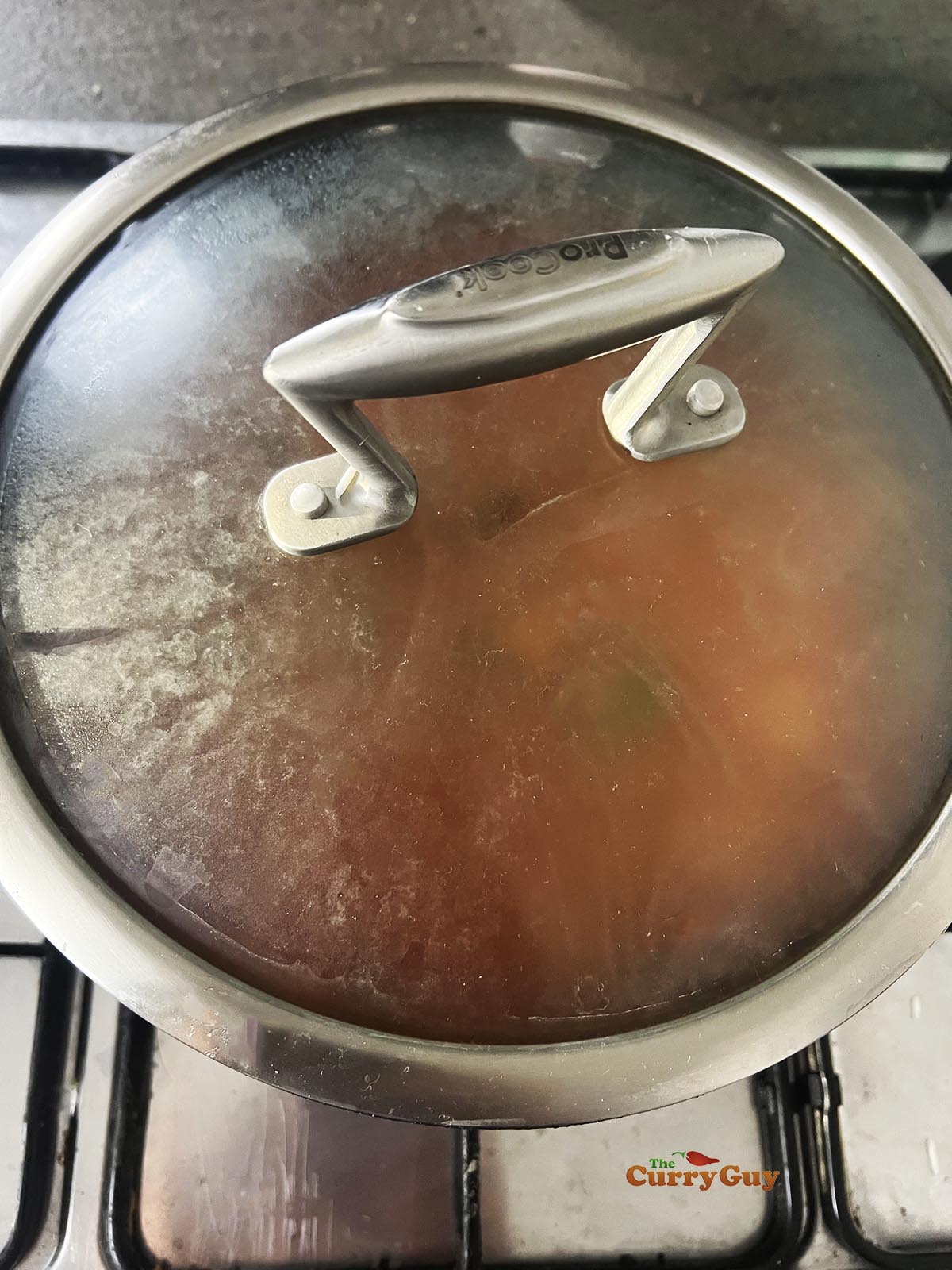 Cooking the rice in the poaching liquid with all the chopped onions and spices.