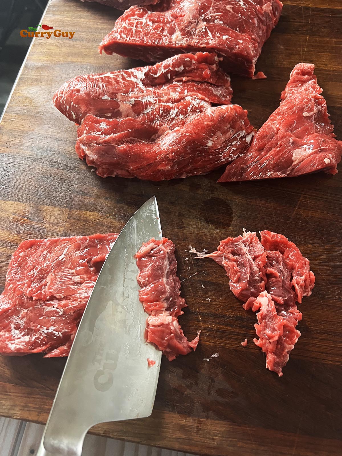 Slicing the steak in preparation for cooking.