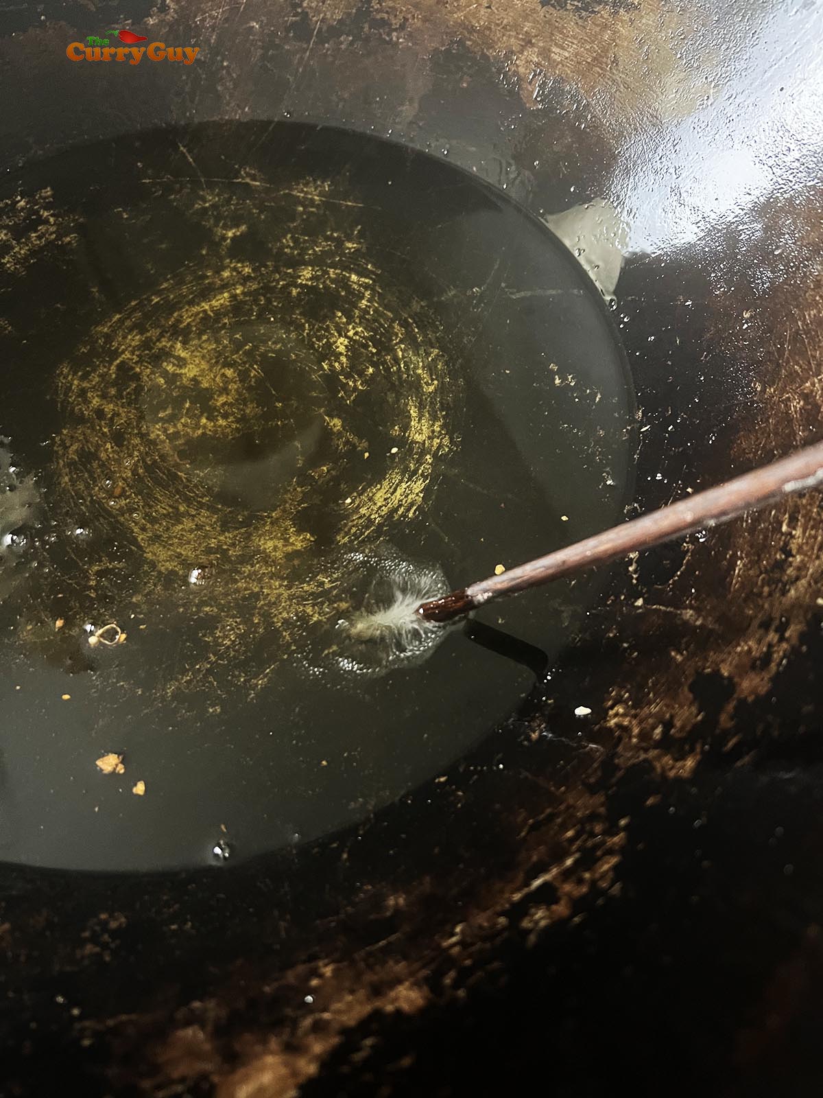 Checking the oil temperature for frying.