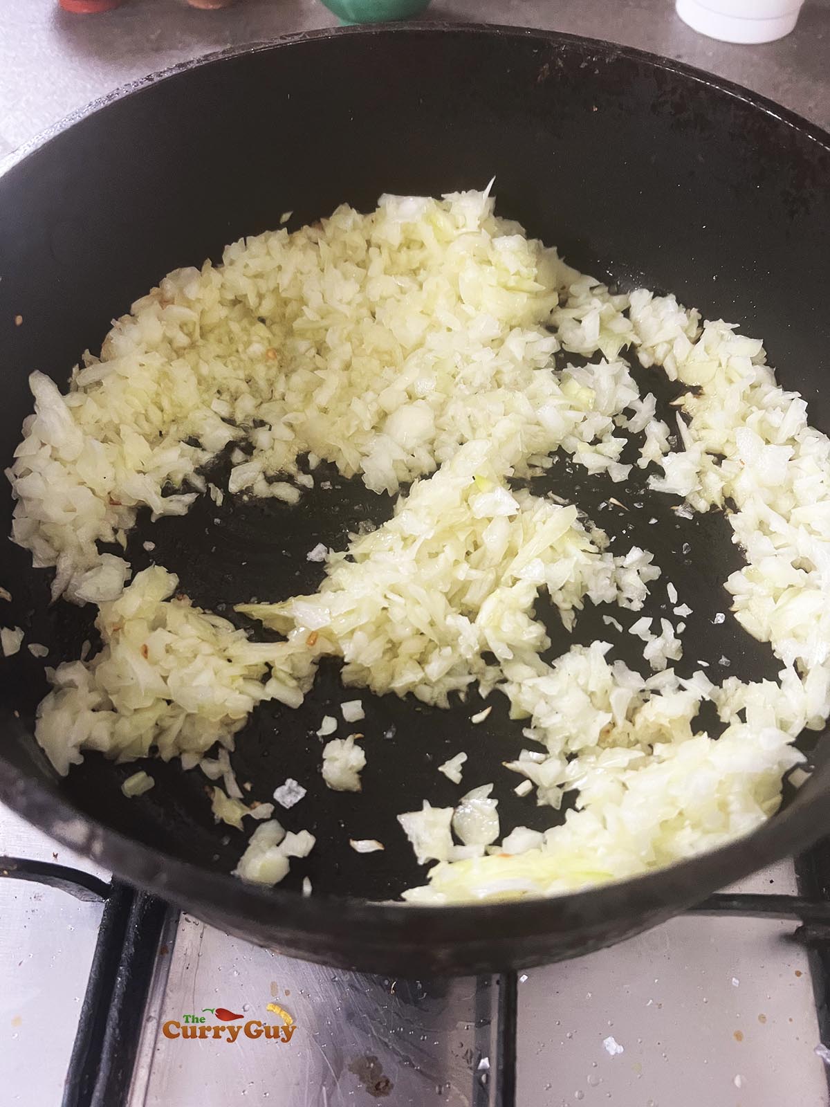 Frying chopped onions in the pan.