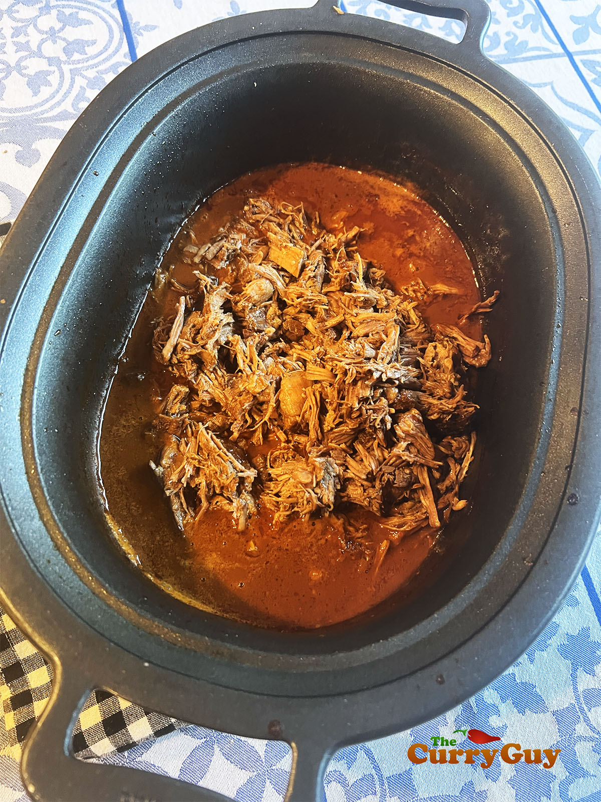 Returning the meat to the reduced broth in the pan. 