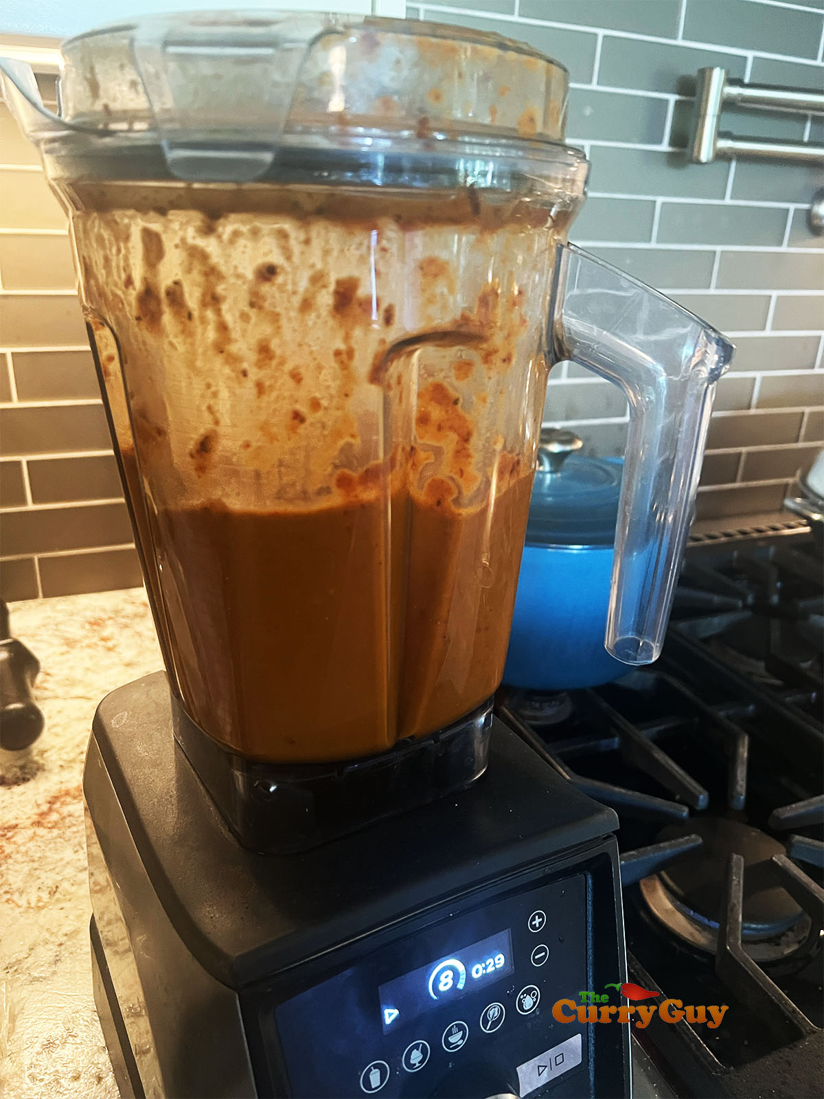 Blending the onions, chilies and spices into a paste.