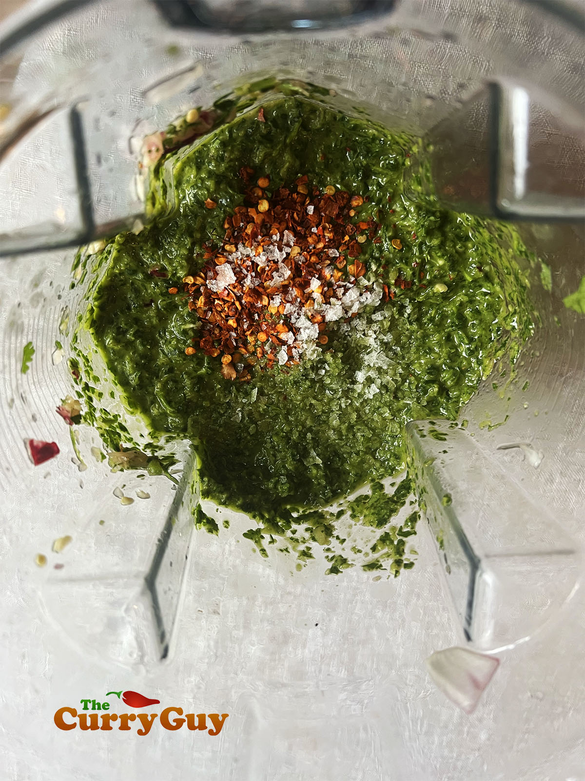 Adding salt, pepper and dried chilies to taste.