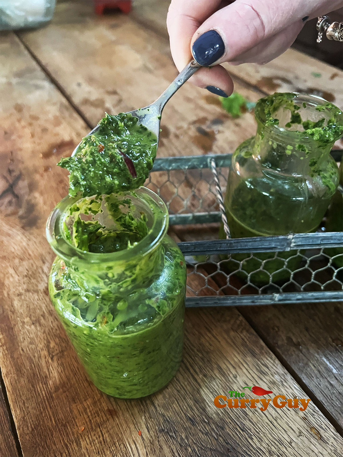 Chimichurri sauce in a glass jar.