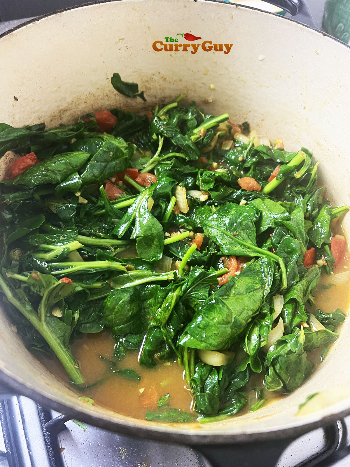Simmering the greens in the pan.