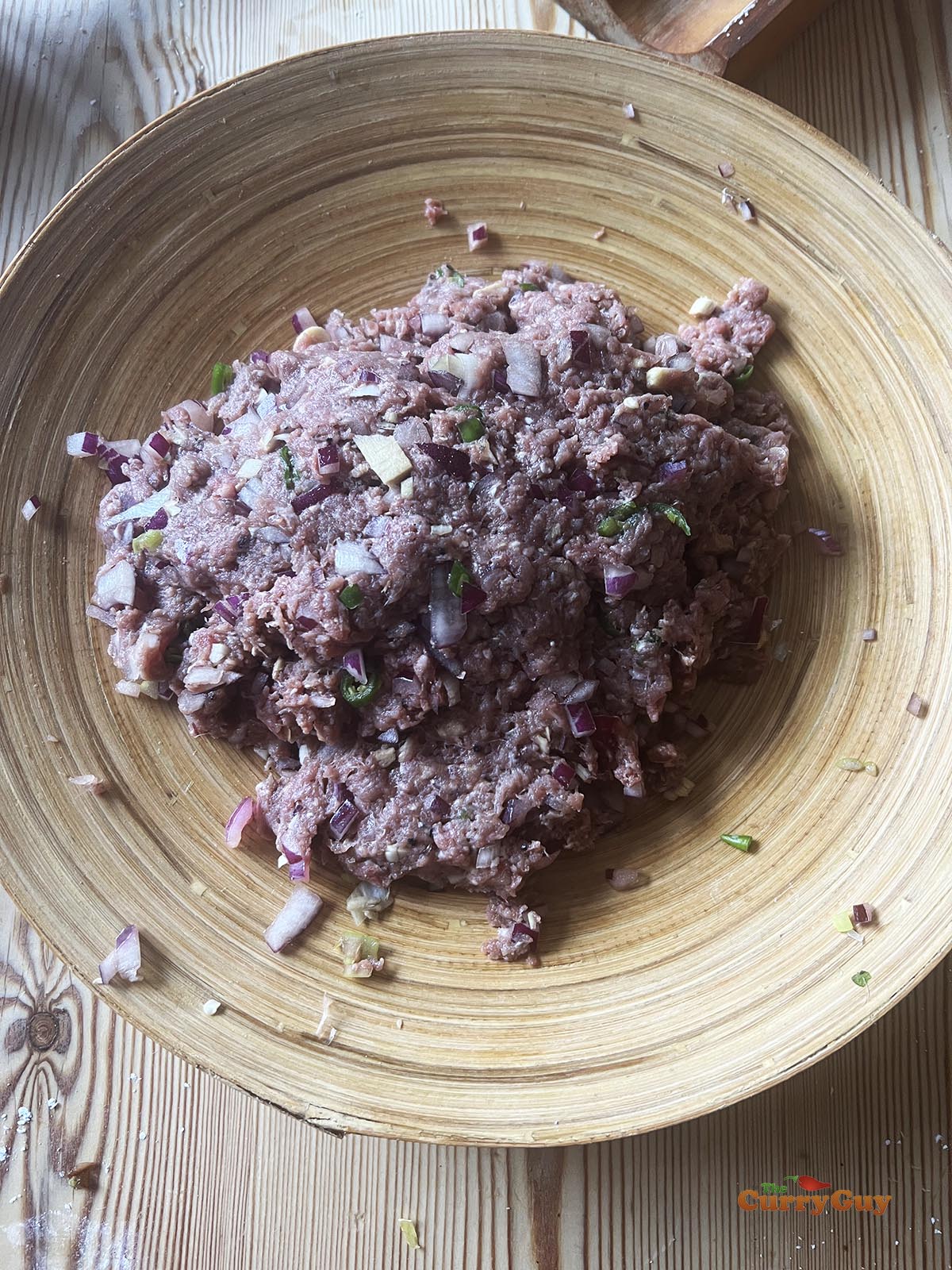 Mixing the meat ingredients together for the filling.