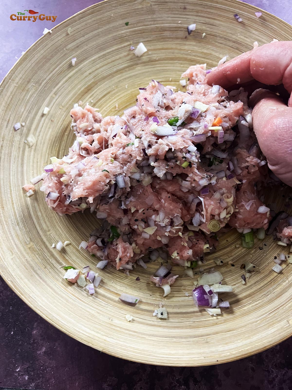 Preparing the chicken stuffing for the momos.