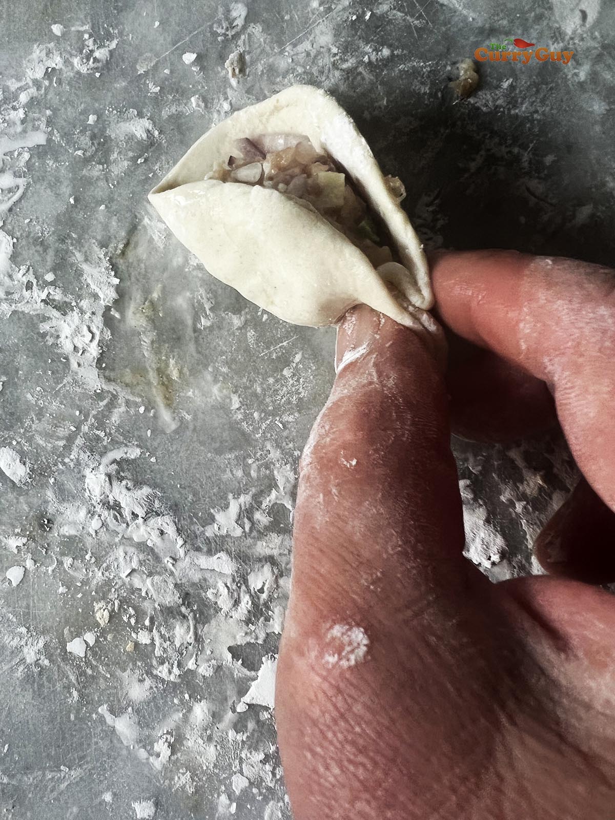 Folding the beef momos.