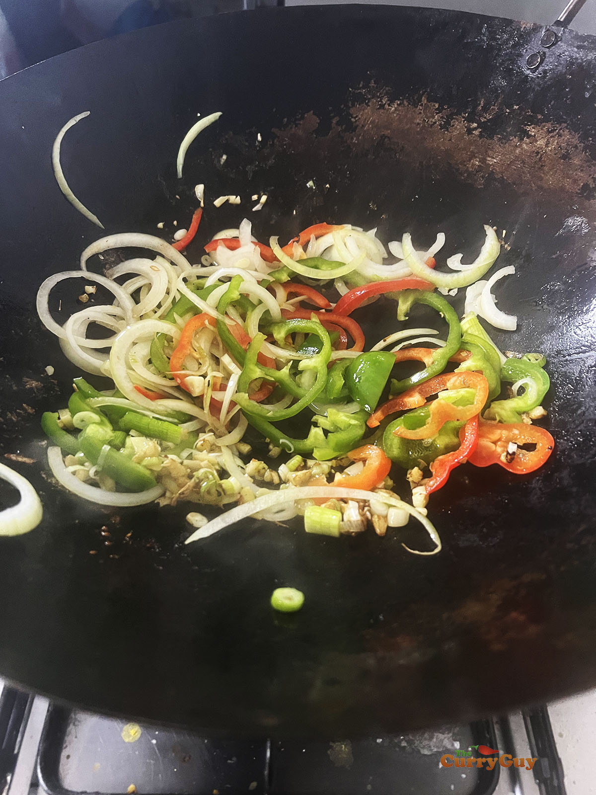 Adding the vegetables to the pan.