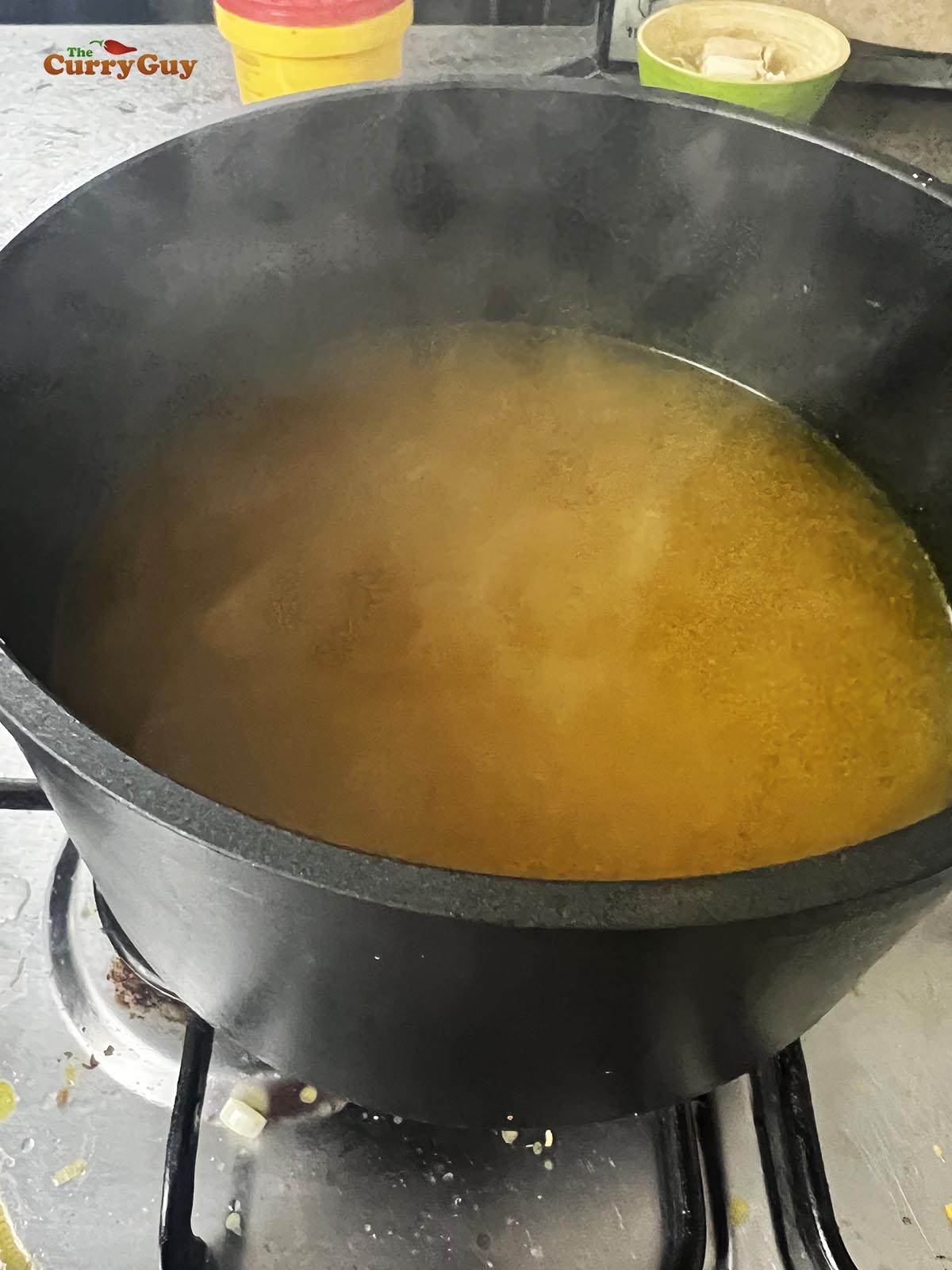 Adding the turmeric, salt, white pepper and sesmae oil to the stock.