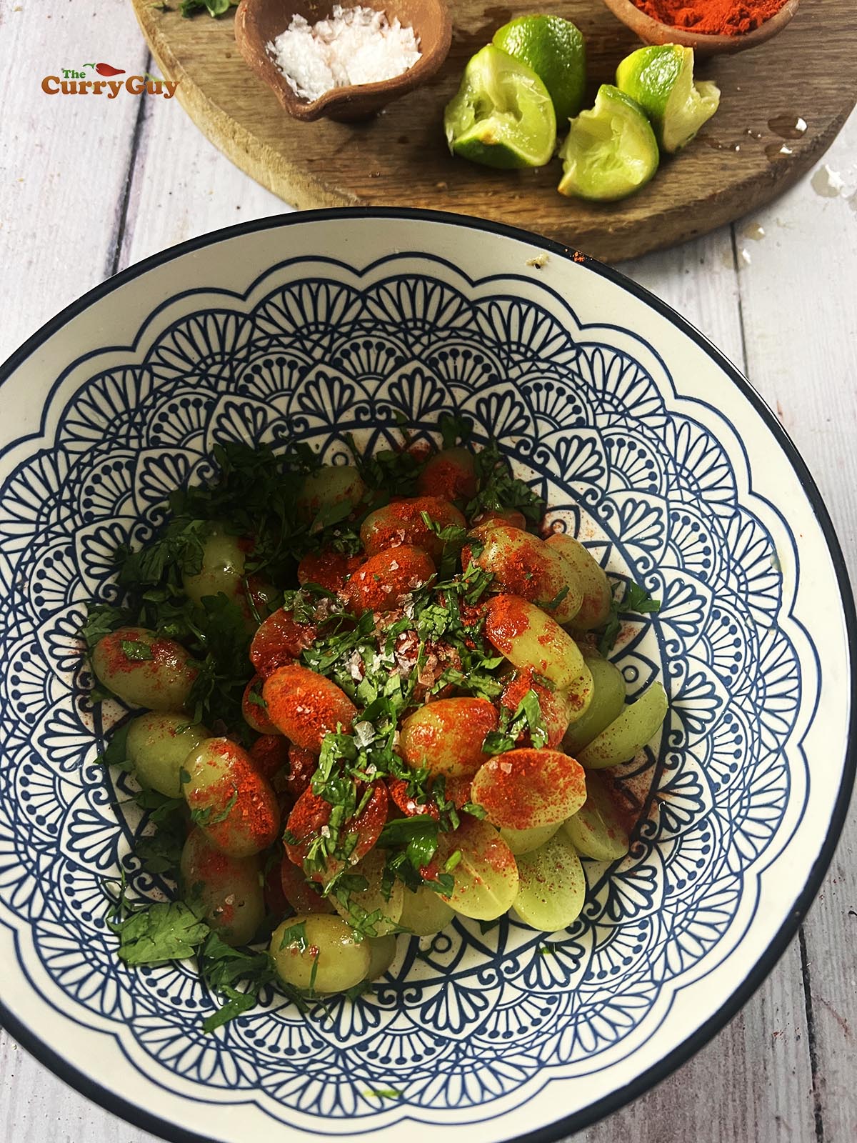 Mixing the grapes with the chili powder, lime juice, salt and coriander (cilantro)