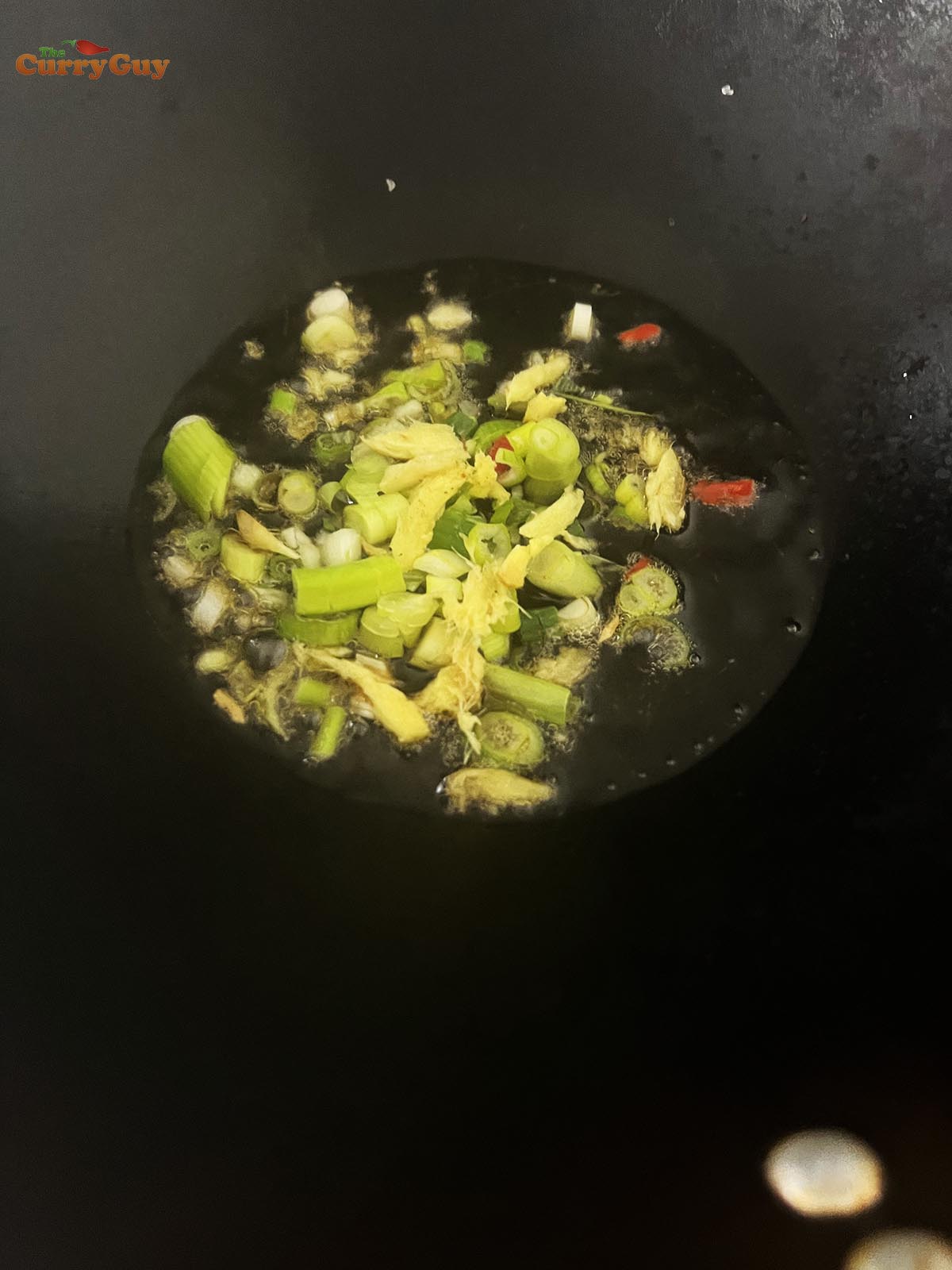 Preparing a sesame, ginger and spring onion (scallion) dipping sauce.