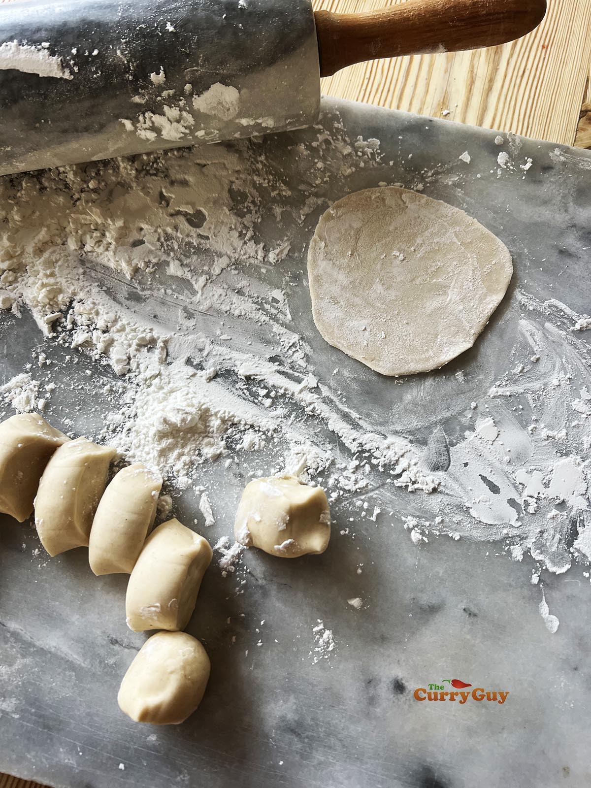 Small dough balls on a floured surface. 
