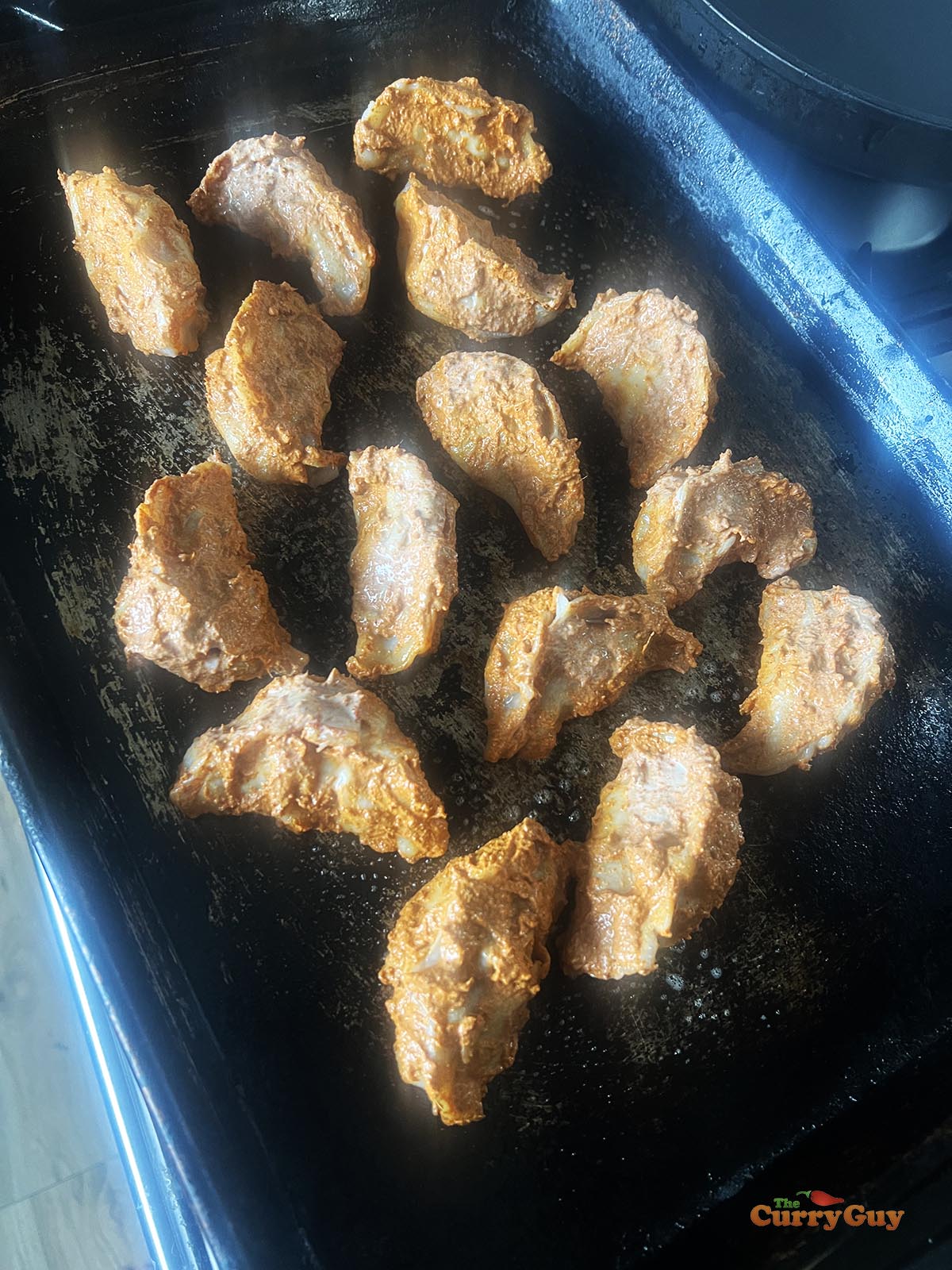 Tandoori momos on a baking tray, ready for roasting.