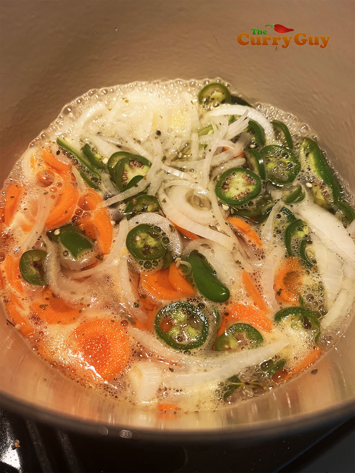 Simmering the pickle ingredients in water and vinegar.