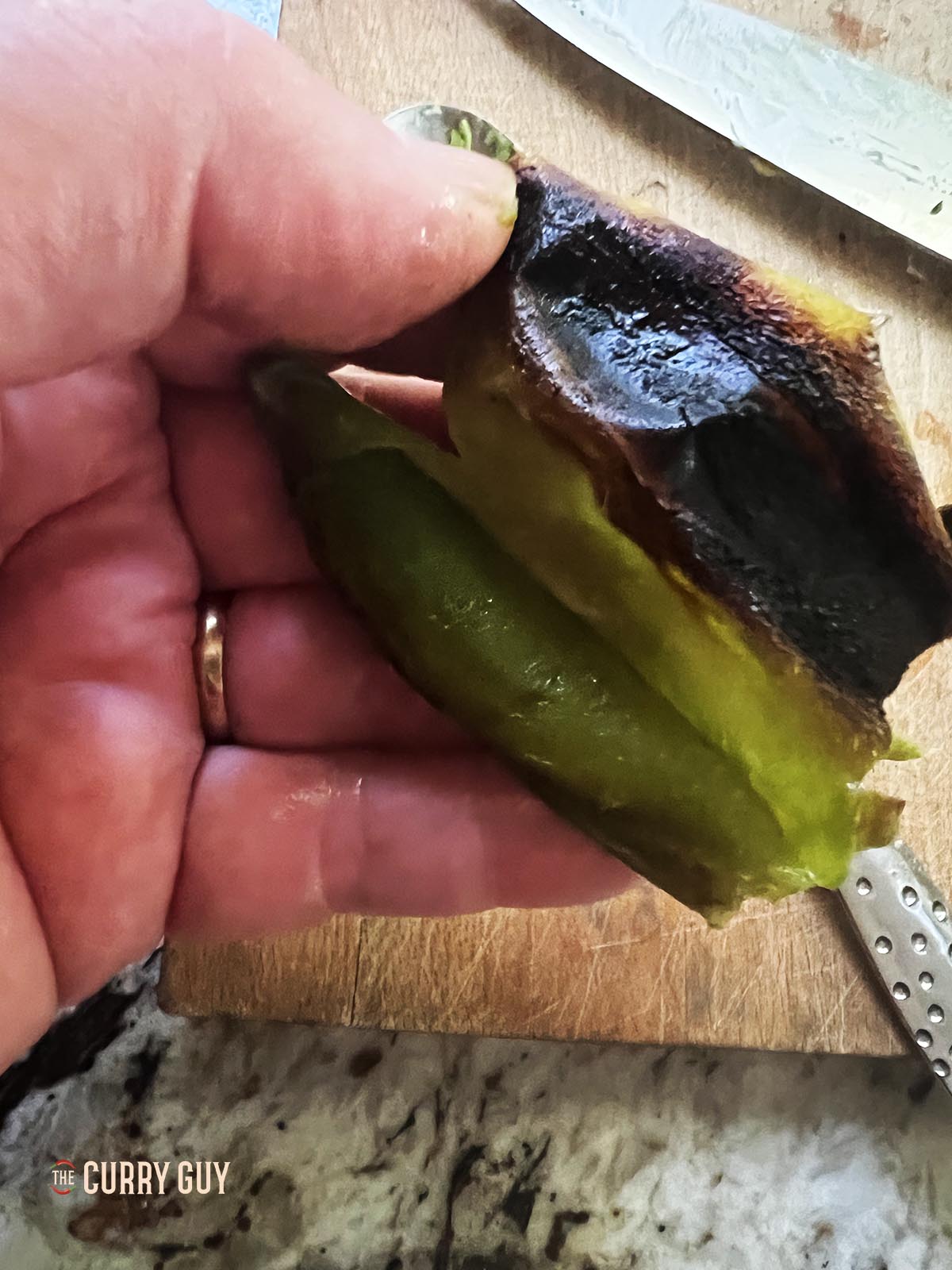 Removing the skins from the chilies.