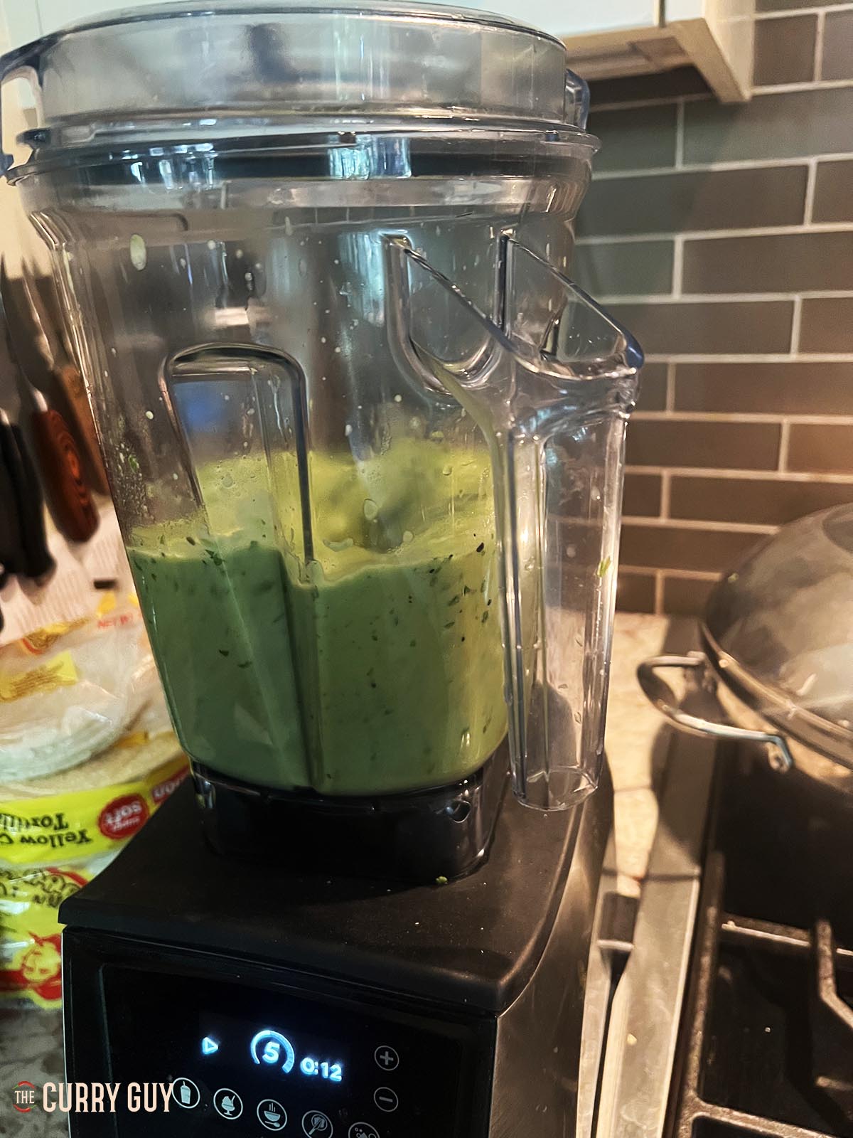 Blending the tomatillo and avocado salsa.