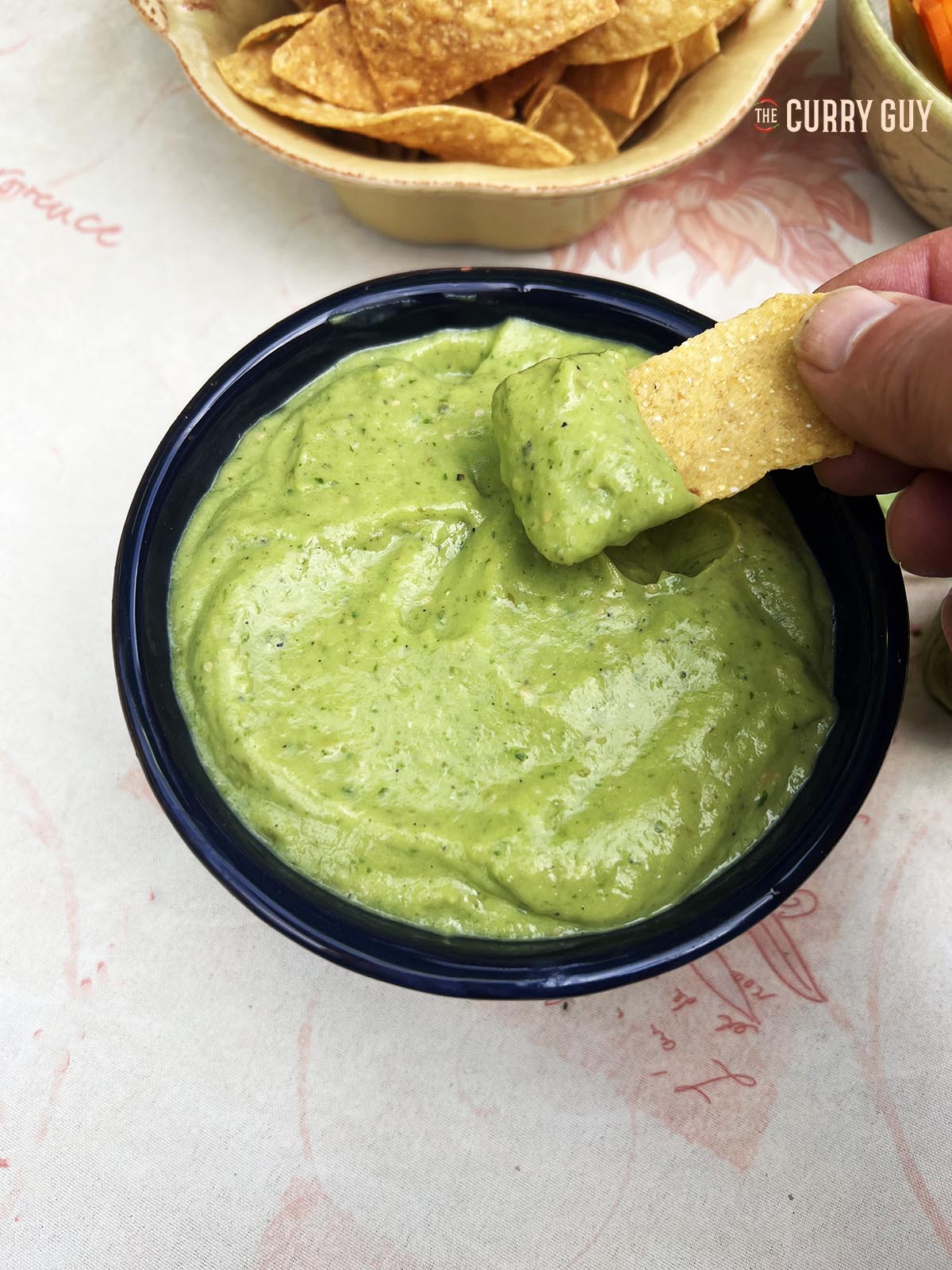 Tomatillo and avocado salsa with corn chips.