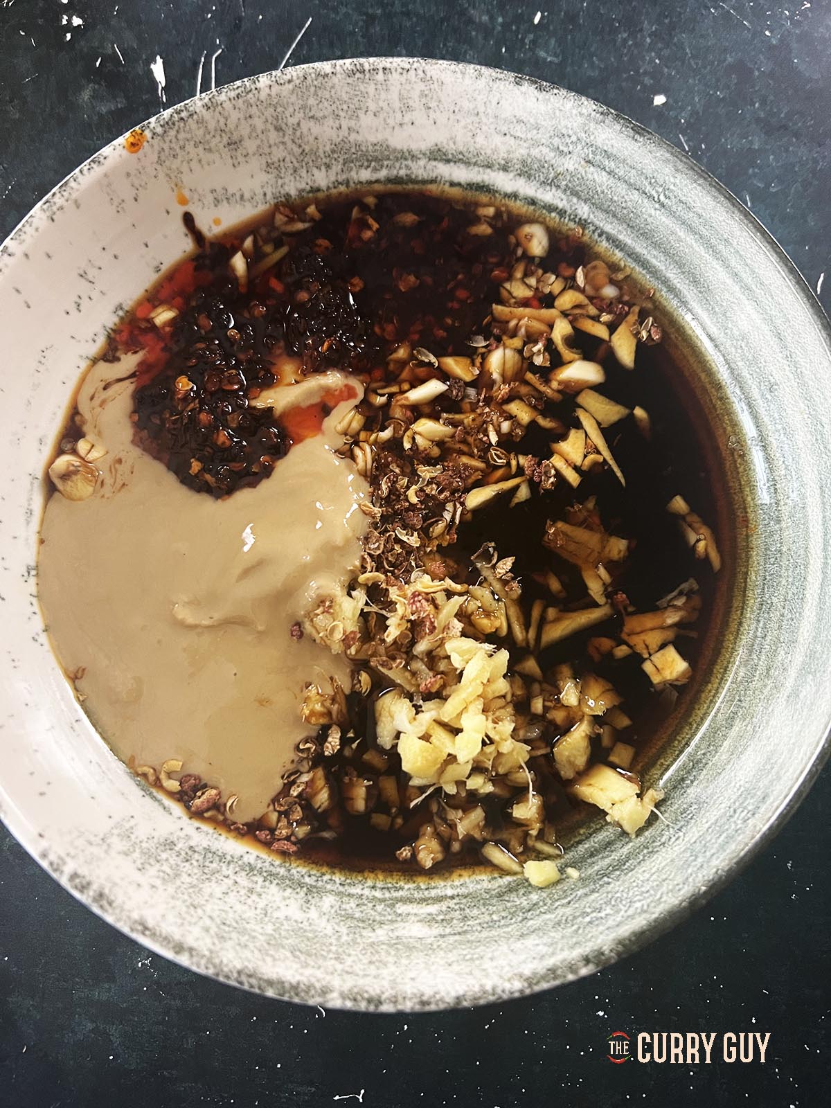 Mixing the sauce ingredients together in a mixing bowl.