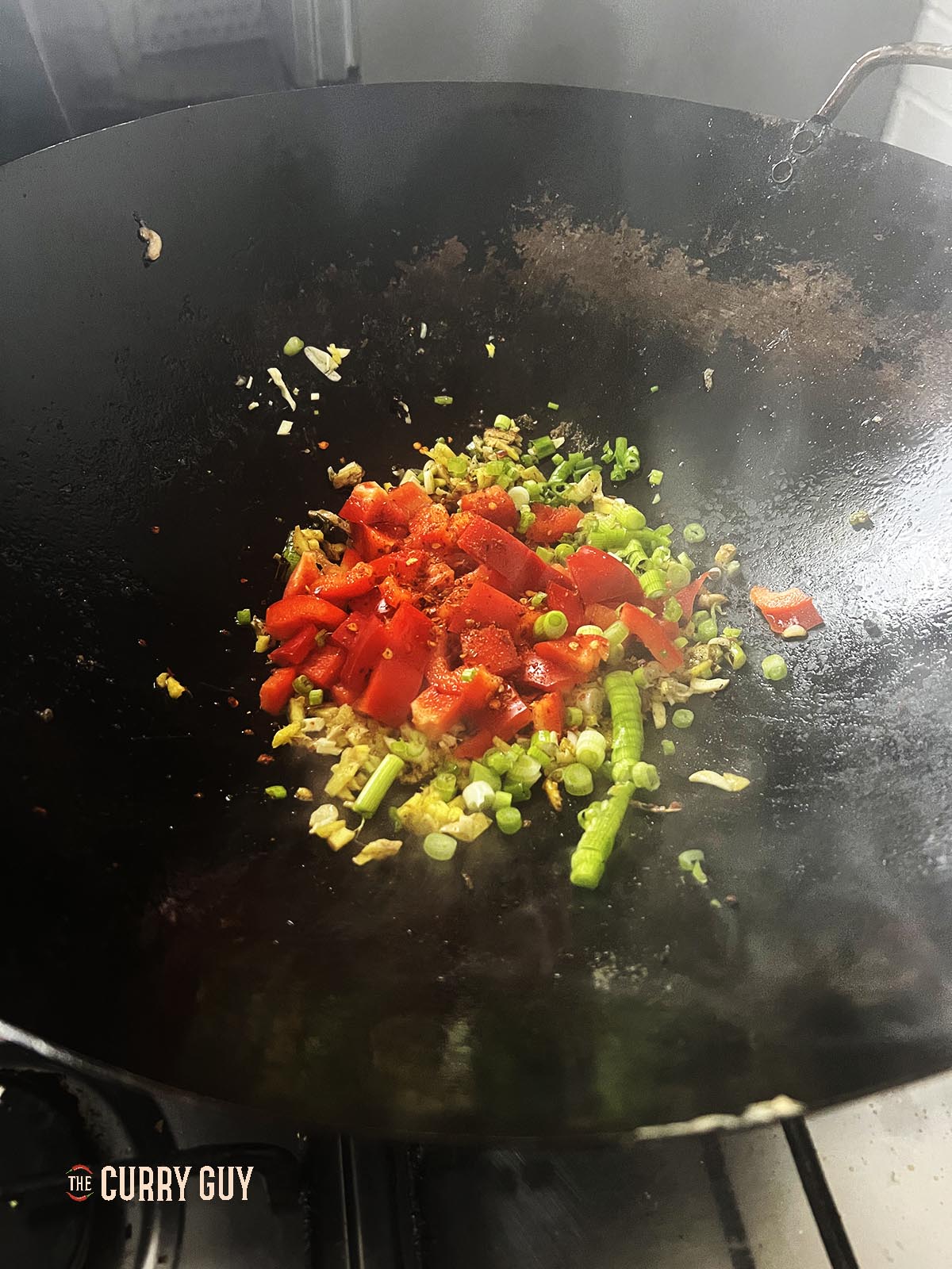 Frying the bell pepper with the aromatic ingredients.