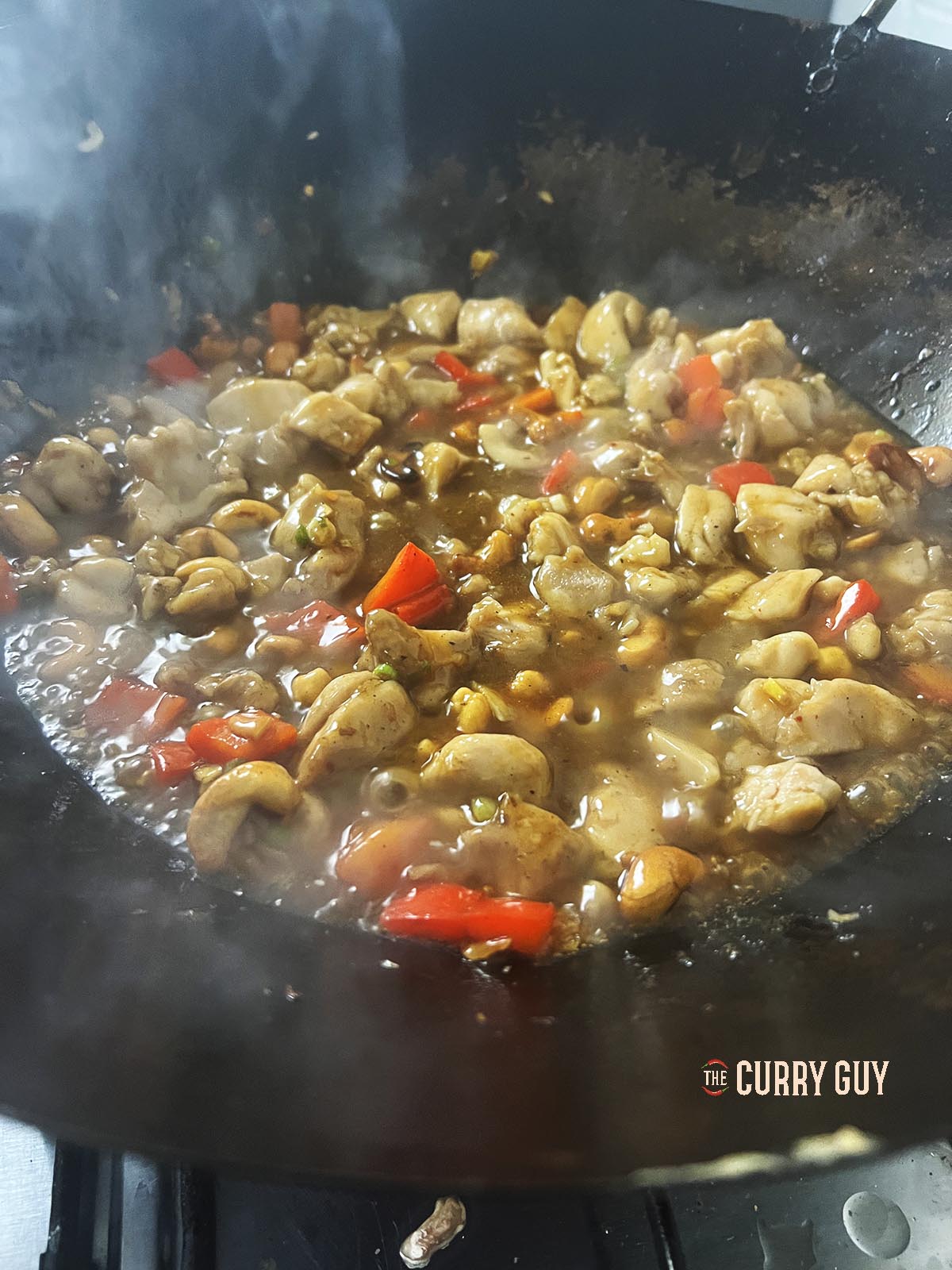 Cashew chicken cooking in a wok. 