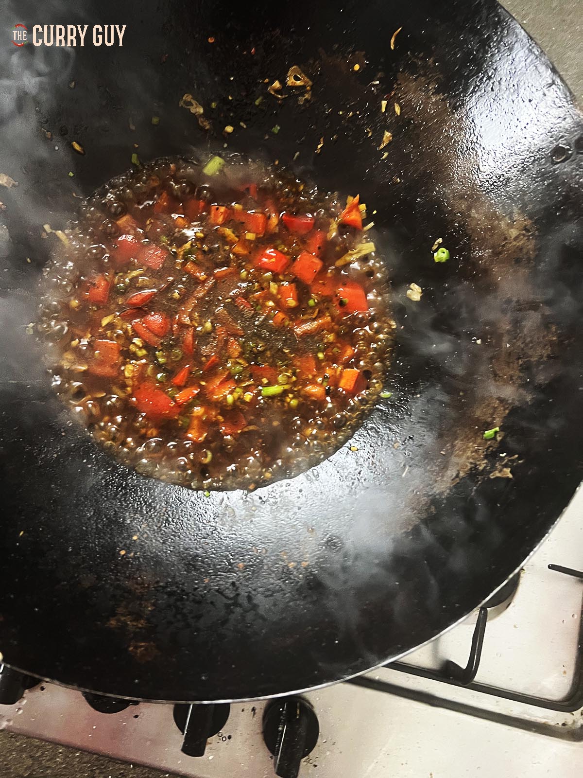 Adding and bringing the sauce to a simmer. 