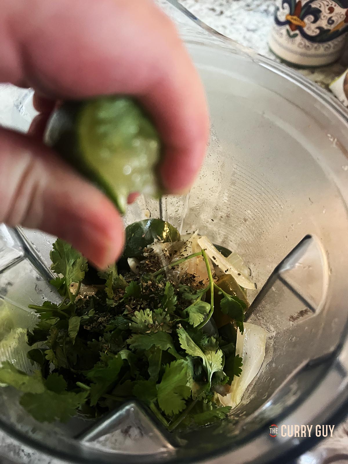 Cooling the chili sauce mixture and adding lime juice and ground black pepper.