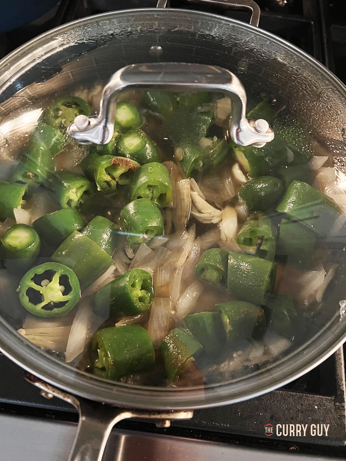 Simmering the chili sauce mixture in a covered pan over a medium heat.
