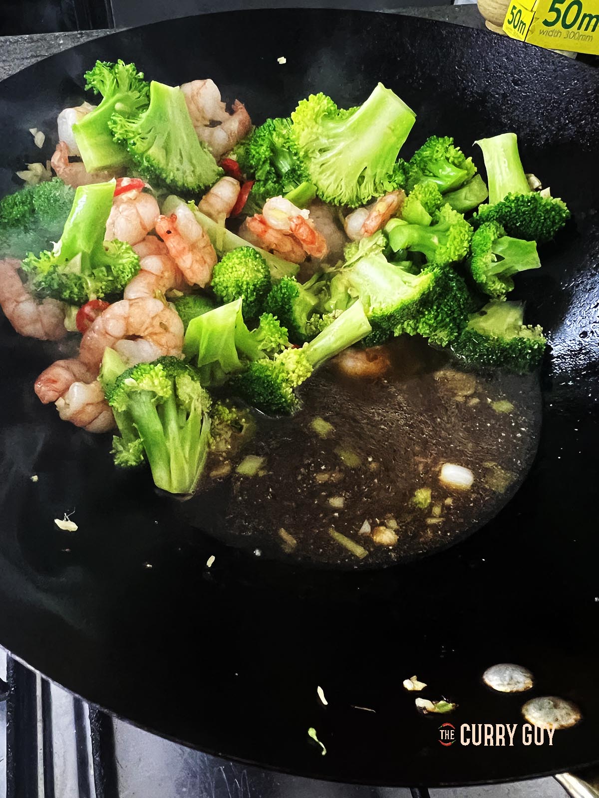 Adding the sauce to the wok.