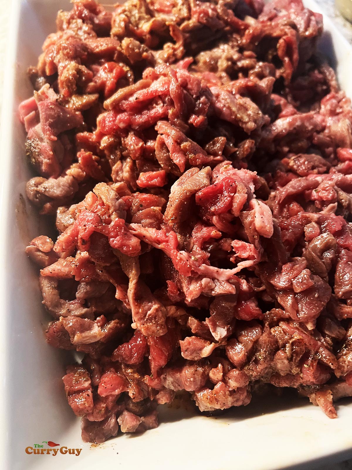 Marinating the beef in preparation for frying.