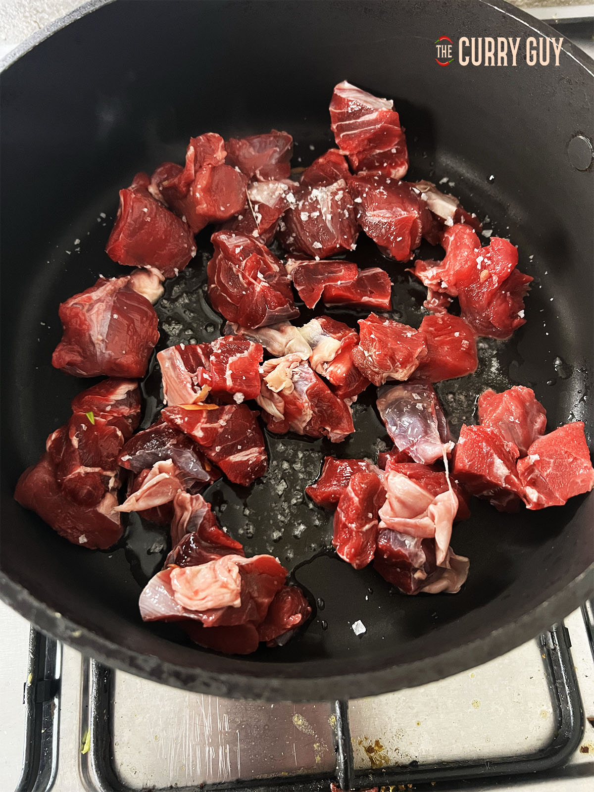 Frying the beef over a medium high heat in the pan to brown it.