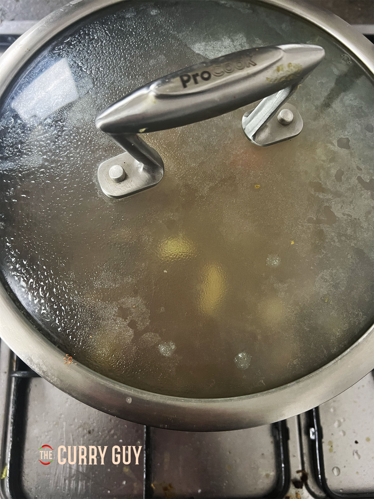 Simmering the beef until tender with the lid on the pan.