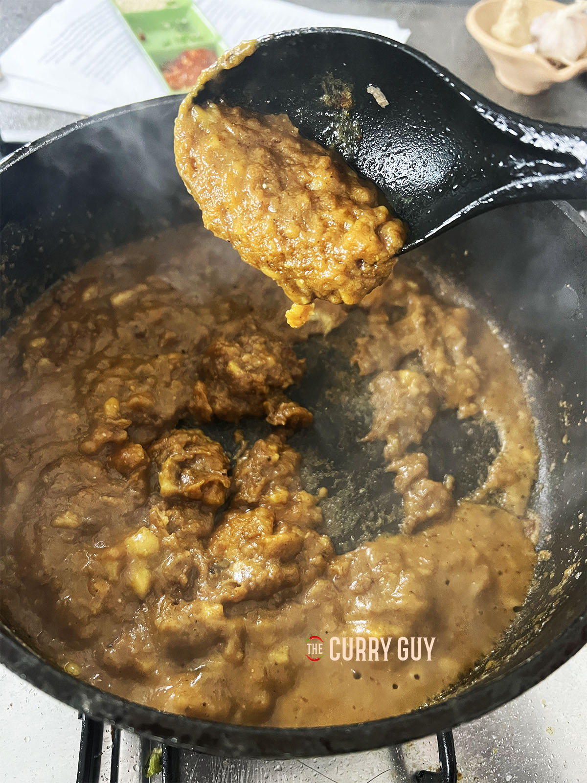 Adding a little stock to the roux to thin it some.