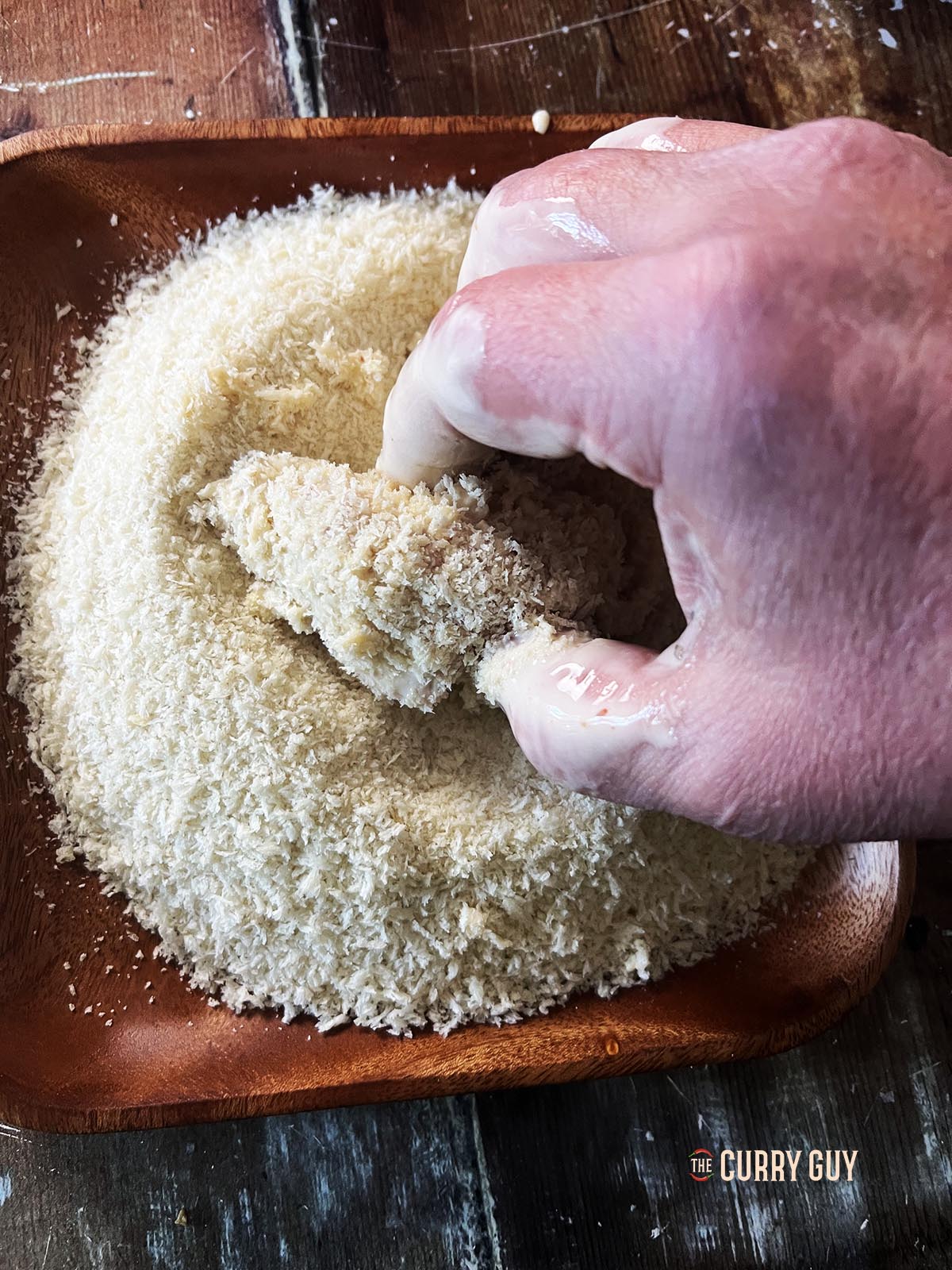 Dipping the battered chicken in the Panko breadcrumbs.