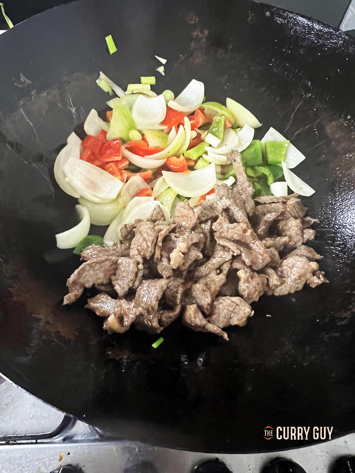Adding the beef to the wok.