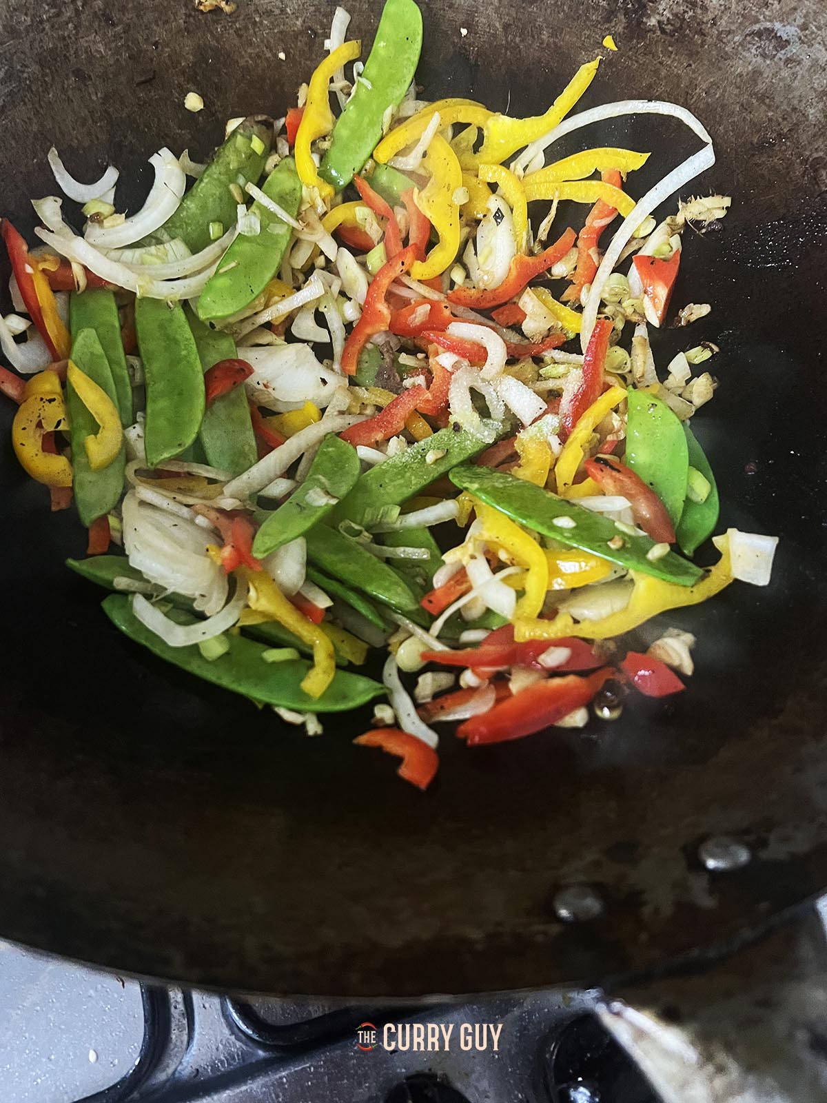 Frying the vegetables in the wok.