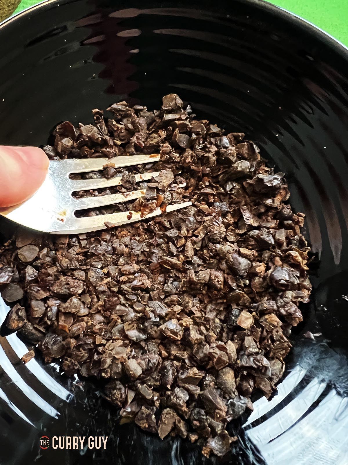 Smashing the black beans.