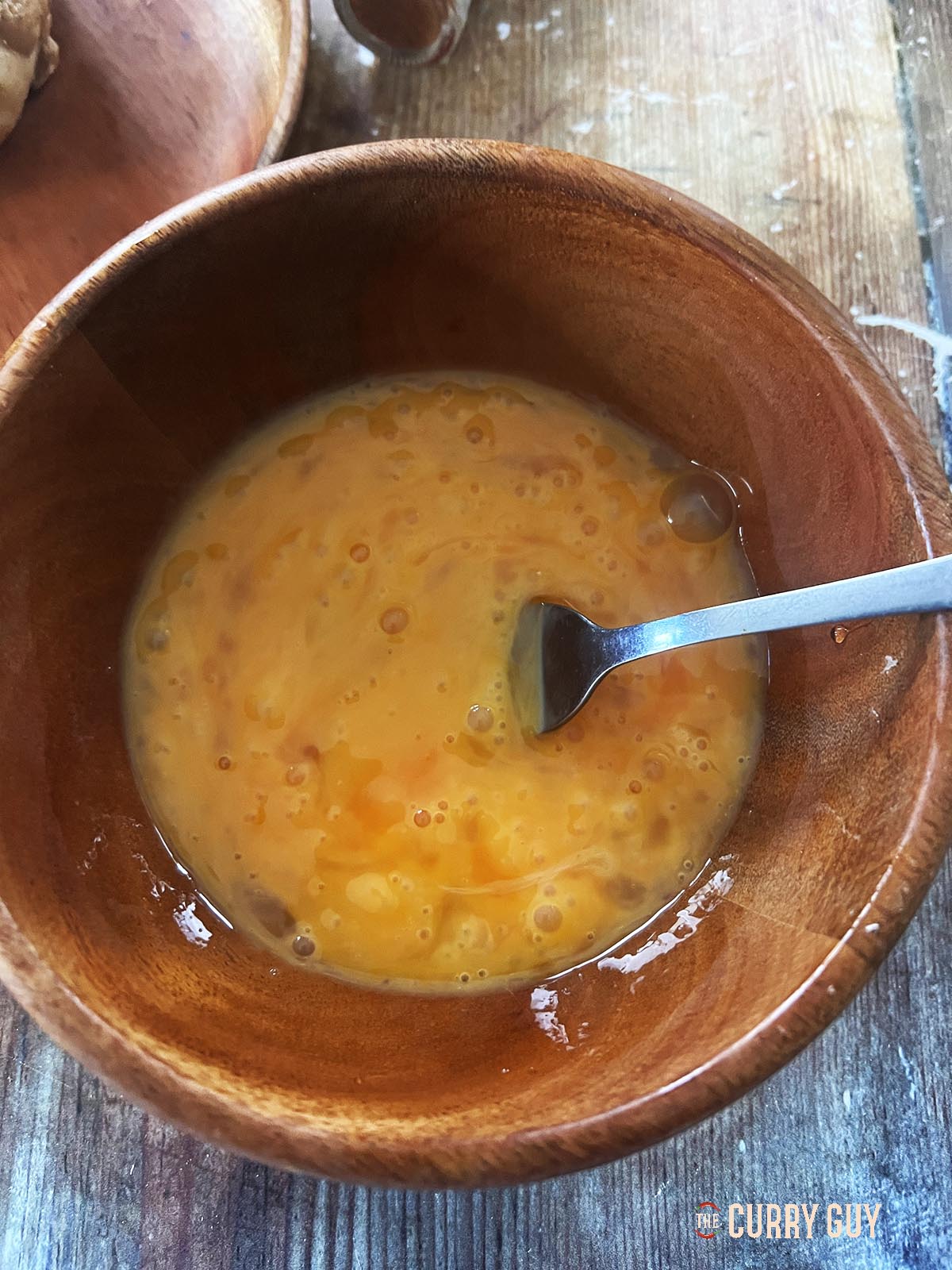 Beaten eggs in a bowl.