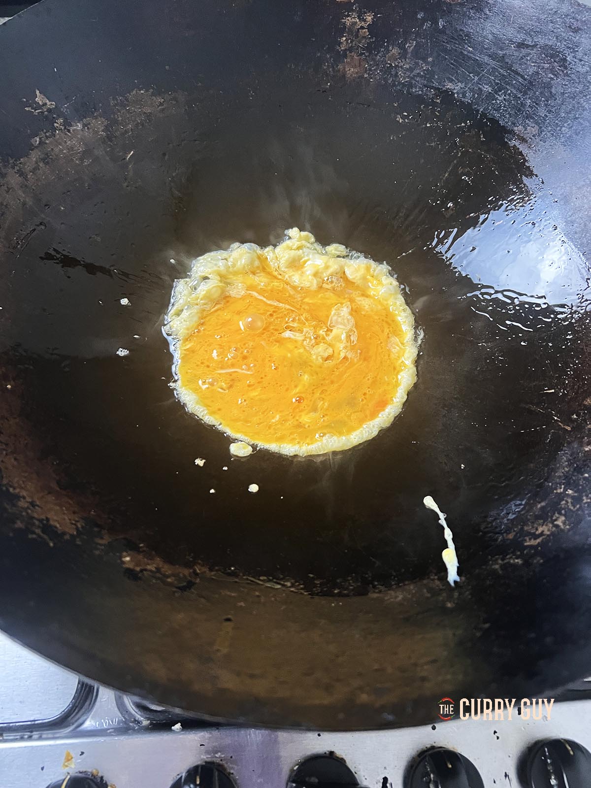 Scrambling eggs in a wok.