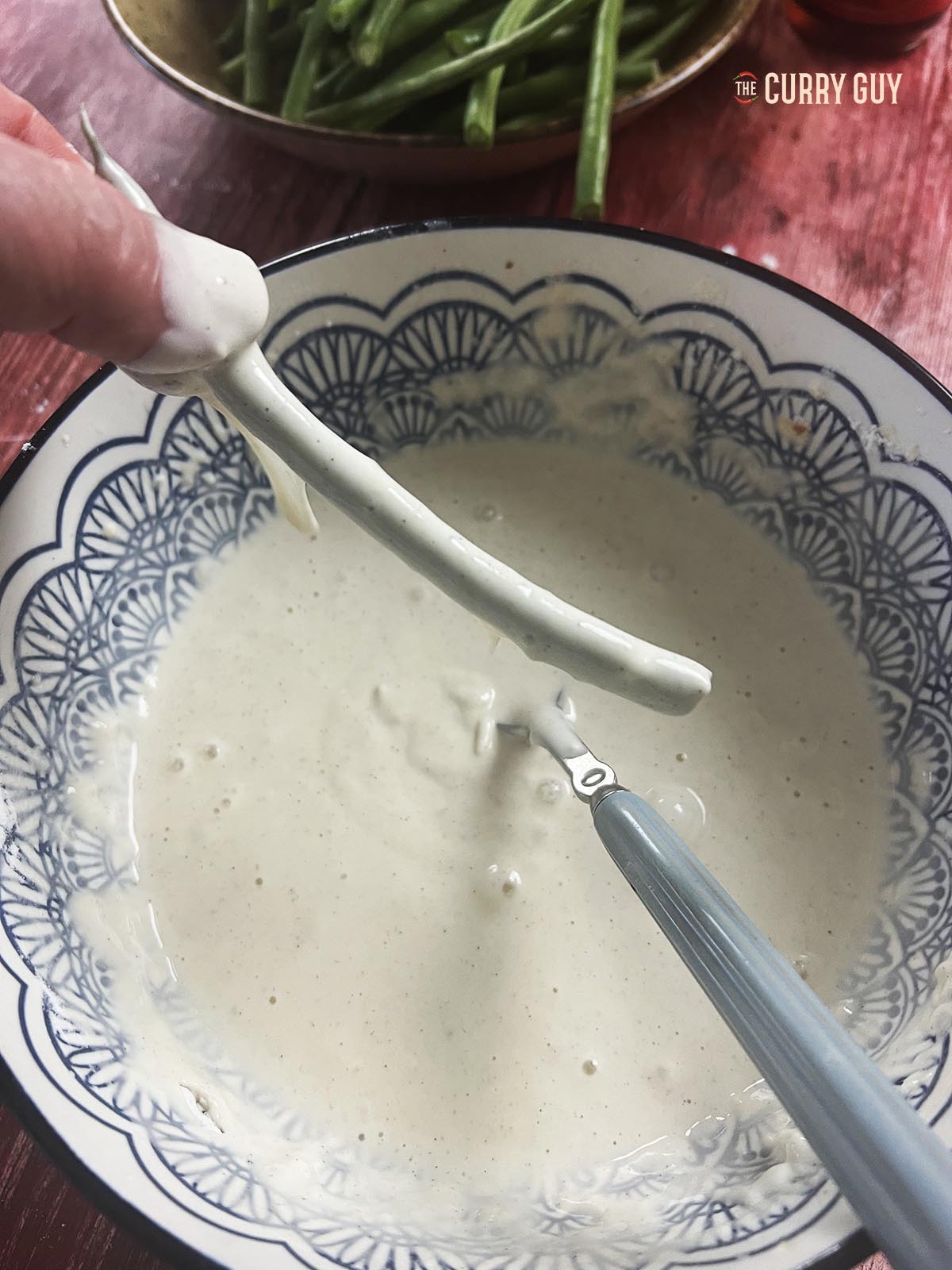 A green bean coated with the batter.