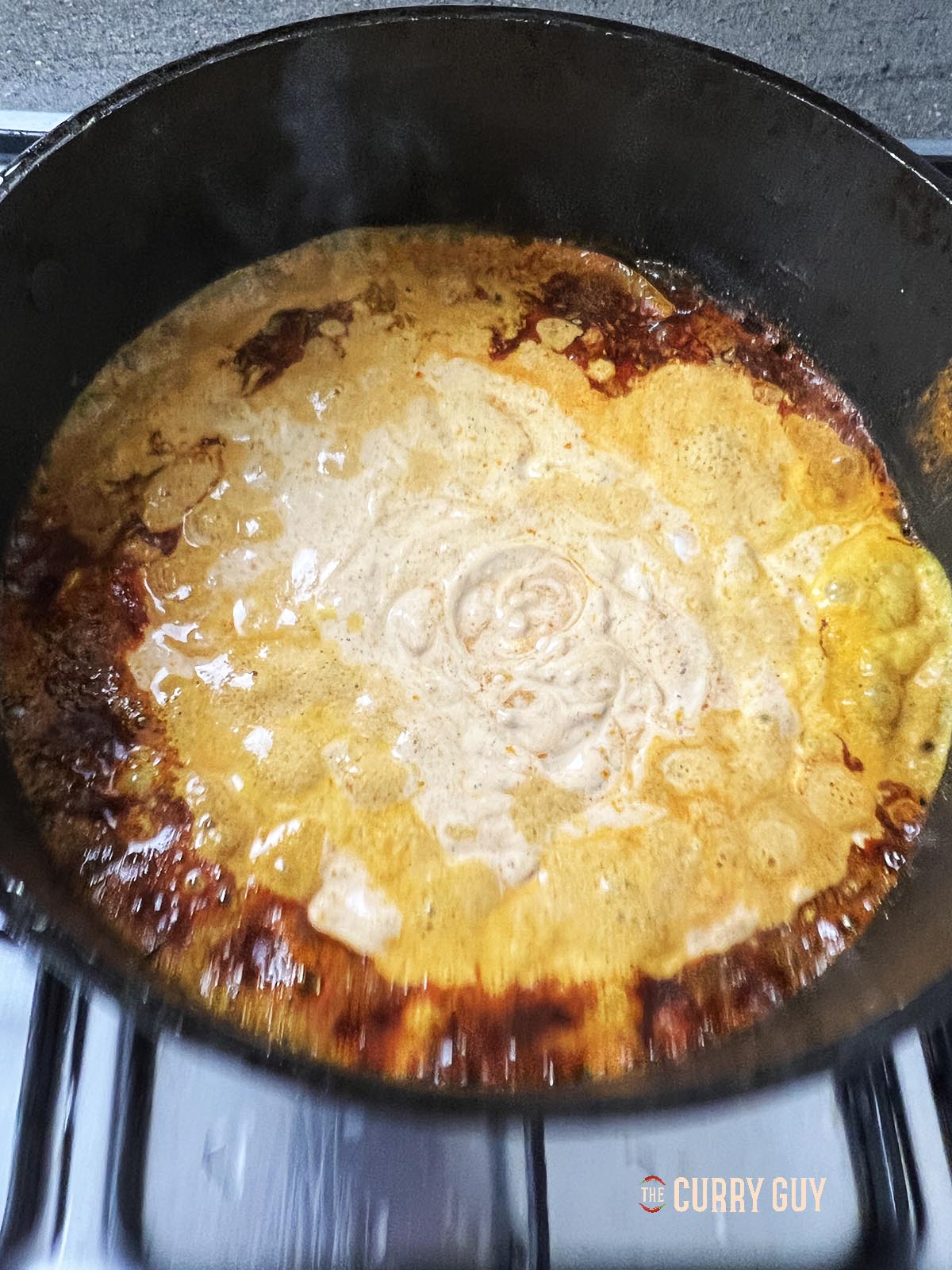 Stirring in the prepared yoghurt and chilli sauce blend.