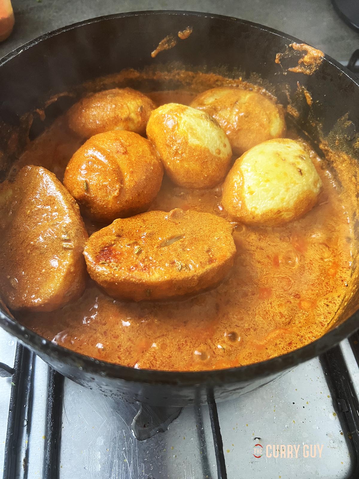 Adding the fried potatoes to the pan.