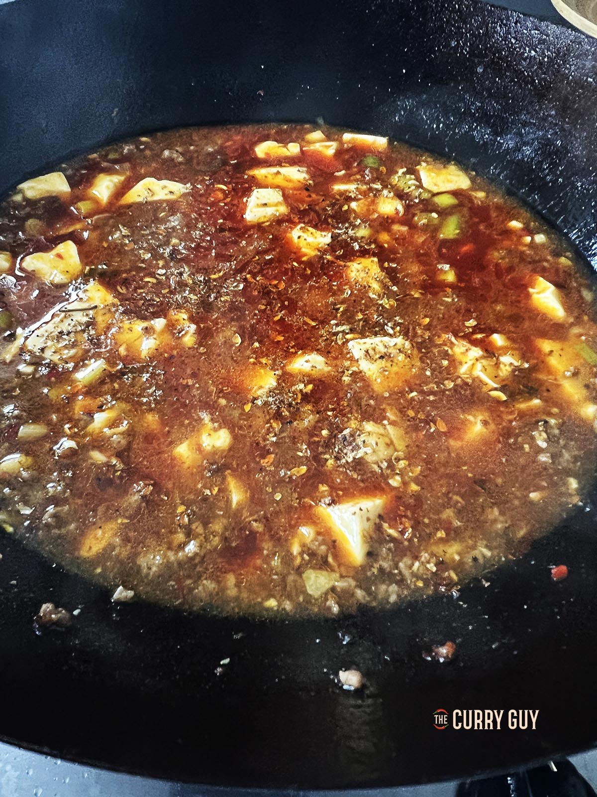 Adding the Sichuan peppercorn powder.