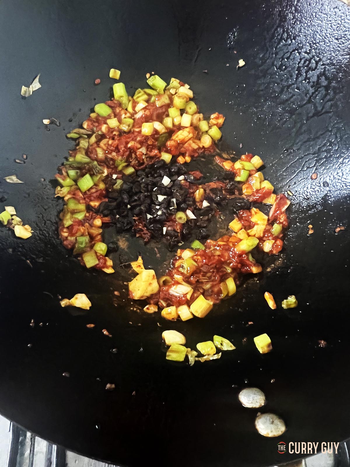Adding the soy sauce and chopped fermented black beans.