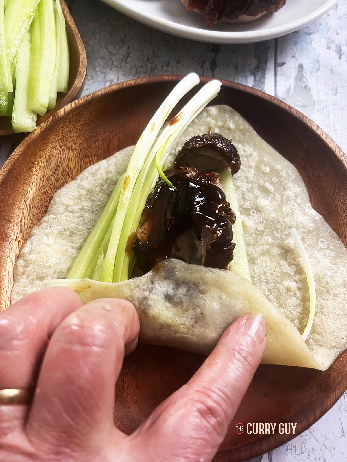 Wrapping a Peking duck wrap.
