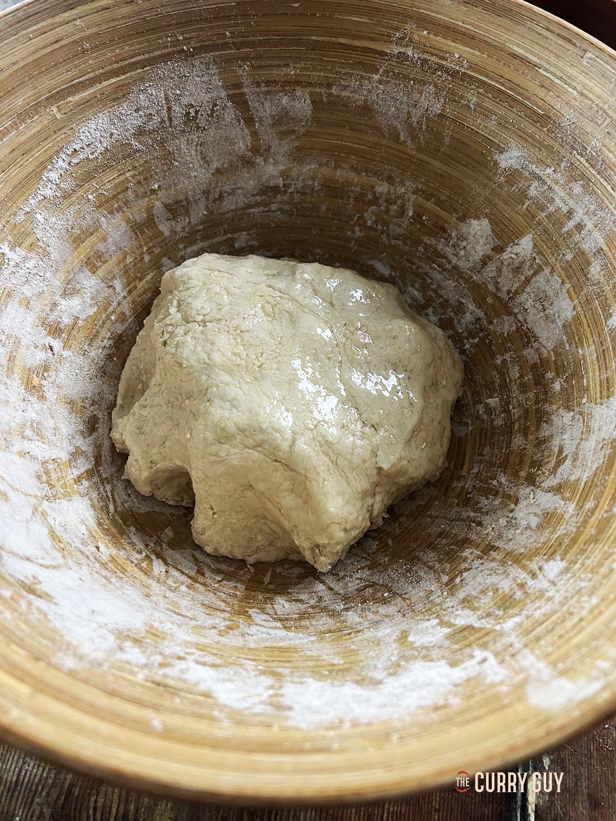 The dough ball resting for an hour in a mixing bowl.