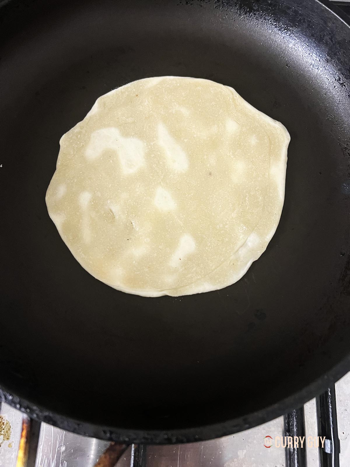 Pancake cooking in a pan.